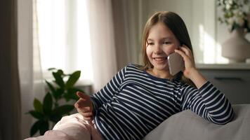 Little girl talking mobile phone smartphone telephone laughing smile communicate call chatting conversation home child kid daughter technology gadget gossip distance dialogue connection contact enjoy photo