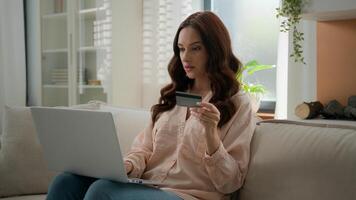 Caucasian girl has problem difficulties with internet bank irritated woman angry female at home hold credit card use laptop computer app try to pay online invalid number error unsuccessful transaction photo