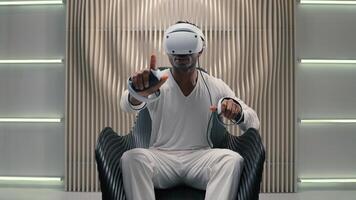 Gamer African American man male guy programmer in VR helmet virtual augmented reality glasses high-tech futurism cyber game online internet interface playing controllers design innovation metaverse photo