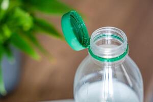 Stationary plastic cap on a PET bottle. The new design means the cap remains attached to the bottle after opening, making the entire package easier to collect and recycle. High quality photo