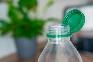 Stationary plastic cap on a PET bottle. The new design means the cap remains attached to the bottle after opening, making the entire package easier to collect and recycle. High quality photo