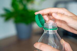 Stationary plastic cap on a PET bottle. The new design means the cap remains attached to the bottle after opening, making the entire package easier to collect and recycle. High quality photo
