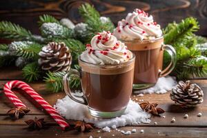 Two hot chocolate mugs with whipped cream and candy canes on a rustic wooden table photo