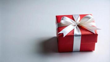 Red Gift Box with White Ribbon on a White Background photo