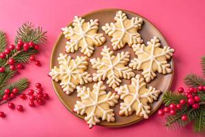 Christmas cookies on a plate with berries and holly branches photo