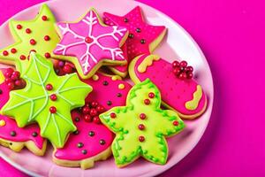 Christmas cookies on a plate on a pink background photo