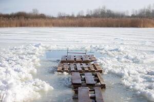 There is an ice hole for walruses to swim in the icy water. Winter baptismal font for the Orthodox feast of the Epiphany. photo