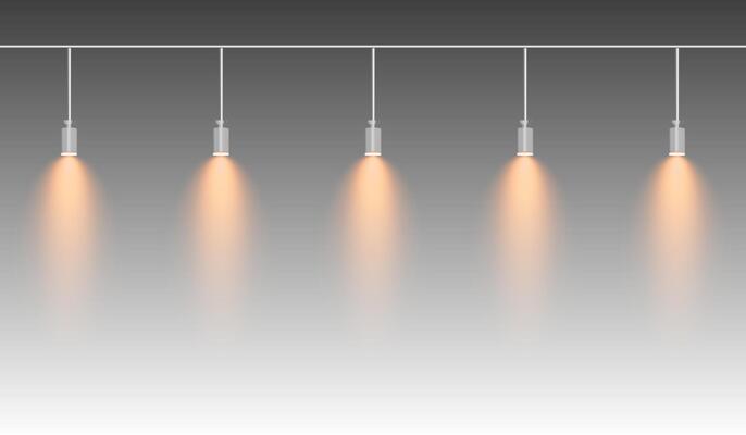 Row of yellow spotlights hanging from a track. Soft glow illuminating downward, creating a modern lighting effect. Ideal for stage lighting, exhibitions, and interior designs. Stage light