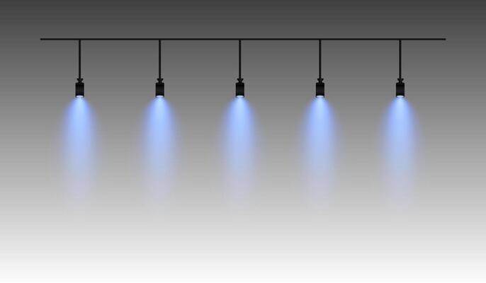 Row of blue spotlights hanging from a track. Soft glow illuminating downward, creating a modern lighting effect. Ideal for stage lighting, exhibitions, and interior designs. Stage light
