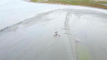 Drone View of Visitors Walking on Tidal Flats Near Mont Saint-Michel video