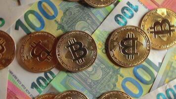 Bitcoin Coins on the 100 Euro Banknotes - Top View. Euro Money Cash and Cryptocurrency. Hundred Euro Bills. Finances, Exchange, Blockchain and Electronic Money Concept - Slow Rotation Right video