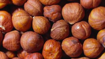 Scattered Peeled Hazelnuts - Top View, Rotating. Turning Hazelnut Background. Natural High-Calorie Snacks - Rotation video