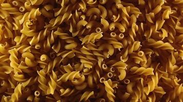 Uncooked Fusilli and Chifferi Rigati Pasta - Top View, Low Key Light. Fat and Unhealthy Food. Classic Dry Macaroni, Slowly Rotating Background. Raw Different Macaroni Pasta Texture - Rotate Right video