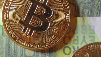 Bitcoin Coins on the 100 Euro Banknotes - Top View, Macro. Euro Money Cash and Cryptocurrency. Hundred Euro Bills. Finances, Exchange, Blockchain and Electronic Money Concept - Rotation Right video