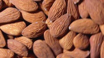 Scattered Almonds - Top View, Rotating. Turning Almond Nuts Background. Natural High-Calorie Snacks - Angular Rotation video