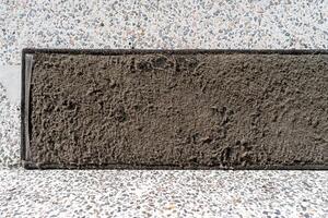 A black square with dirt on it photo