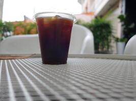 A cup of iced coffee sitting on a table photo
