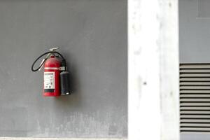 A fire extinguisher is mounted on the wall photo
