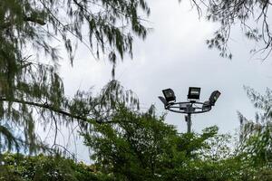 A street light with four lights on top of it photo
