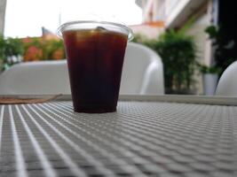 A cup of iced coffee sitting on a table photo