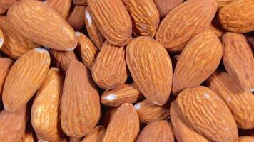 Scattered Almonds - Top View, Rotating. Turning Almond Nuts Background. Natural High-Calorie Snacks - Rotation video