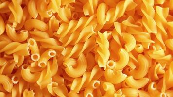 Uncooked Fusilli and Chifferi Rigati Pasta - Top View, Close-Up. Fat and Unhealthy Food. Classic Dry Macaroni, Rotating Background. Raw Different Macaroni Pasta Texture - Rotate Right video