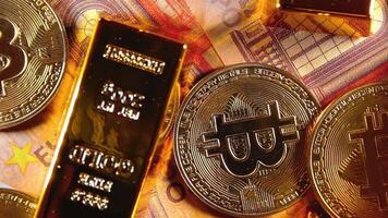Shiny Gold Bars with Bitcoin on the 50 Euro Bills - Top View. Euro Money Currency. A Lot of Fifty Euro Banknotes. Success, Finances, Cryptocurrency and Wealth Concept - Slow Rotation Left video