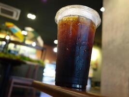 A cup of iced coffee sitting on a table photo