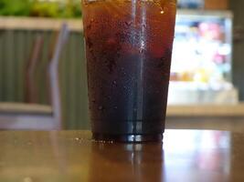 A glass of iced tea sitting on a table photo