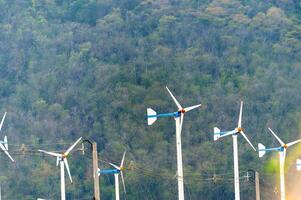 A group of wind turbines in the middle of a field photo