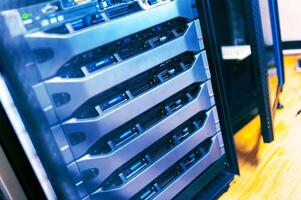 A close up of a server rack with several different types of servers photo