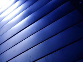 A blue wall with a blue light shining through it photo