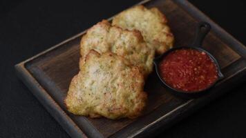 Delicious fried pork or chicken chops breaded with salt and spices on a dark concrete background video
