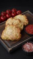 Delicious fried pork or chicken chops breaded with salt and spices on a dark concrete background video