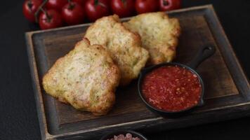 Delicious fried pork or chicken chops breaded with salt and spices on a dark concrete background video