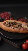 Hotdog with grilled sausage with bacon and mushrooms in a bun with salt, spices and herbs video