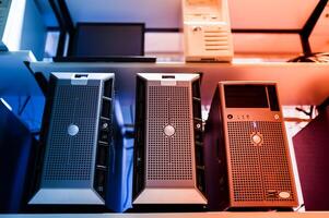 A row of computer towers on a shelf photo
