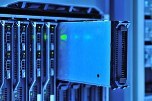 A close up of a server rack with many different types of servers photo