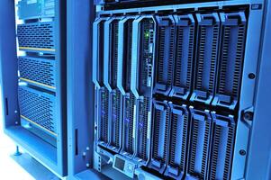A close up of a server rack with multiple servers photo