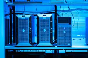 A row of computers in a room with blue lighting photo