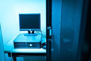 A computer monitor sitting on top of a desk photo