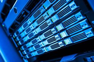 A close up of a server rack with many servers photo