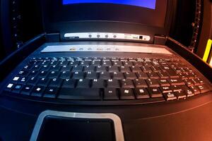 A laptop computer with a keyboard and mouse photo