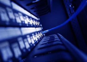 A close up of a network server with a blue cable photo