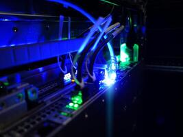 A computer with wires and blue lights photo