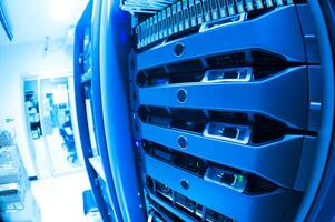 A close up of a server rack with many different types of servers photo