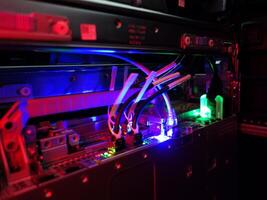A computer with a blue and red light photo