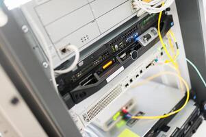 A server rack with multiple wires connected to it photo