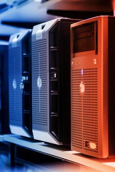 Several computer servers are lined up on a shelf photo