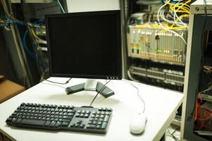 A computer monitor and keyboard on a table photo